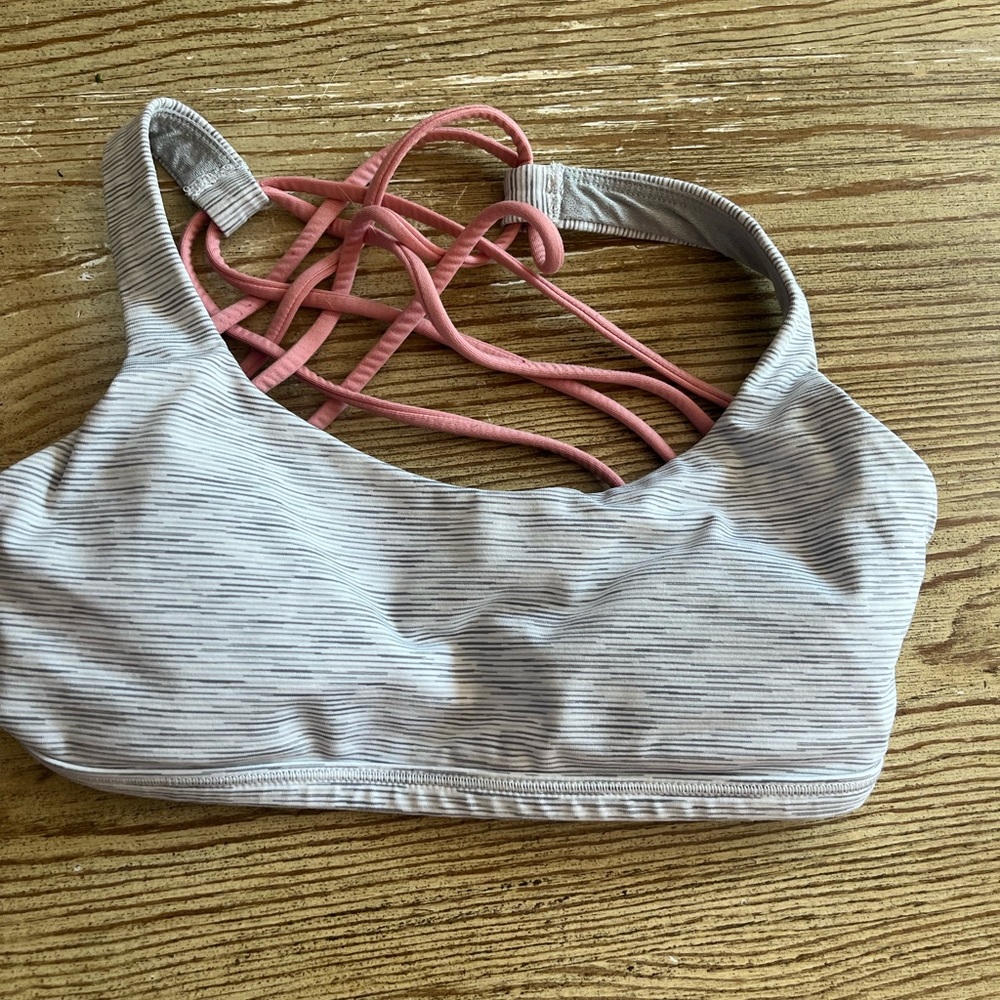 Size zero Lululemon sports bra. Excellent condition. Grey with pink straps
